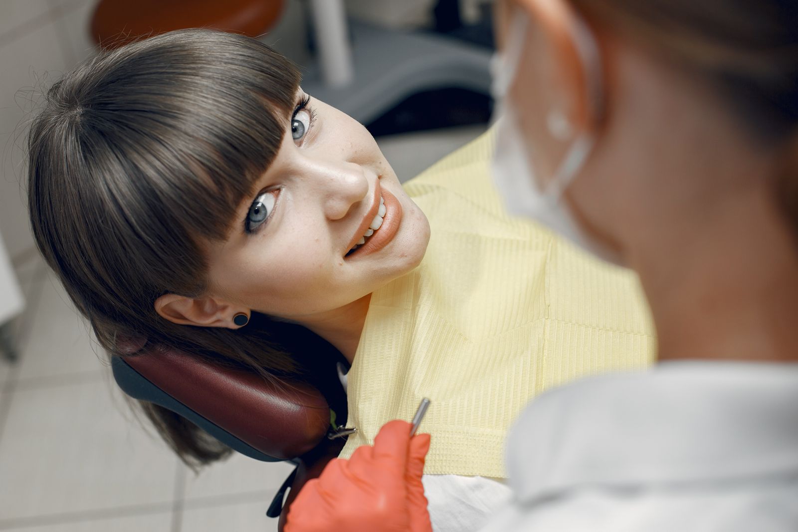 Young woman smiling comfortably during a dental check-up