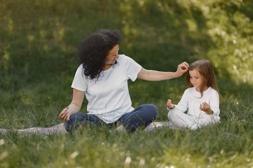 Free A Woman Doing Yoga with her Daughter Stock Photo