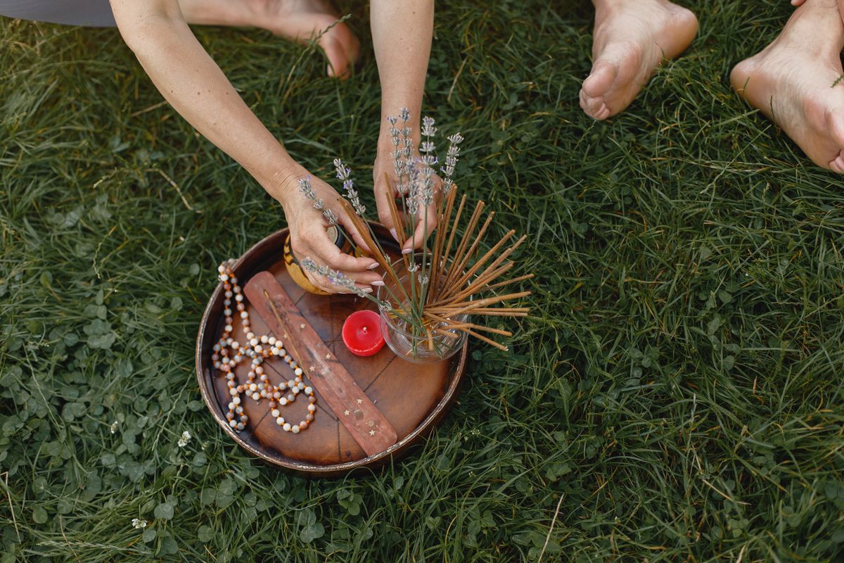 Incense sticks and flowers creating a calm meditative atmosphere, reflecting the Ayurvedic use of sensory environment to support meditation practice