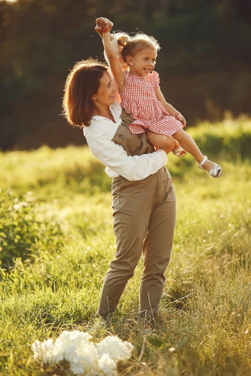 A Woman Carrying her Daughter