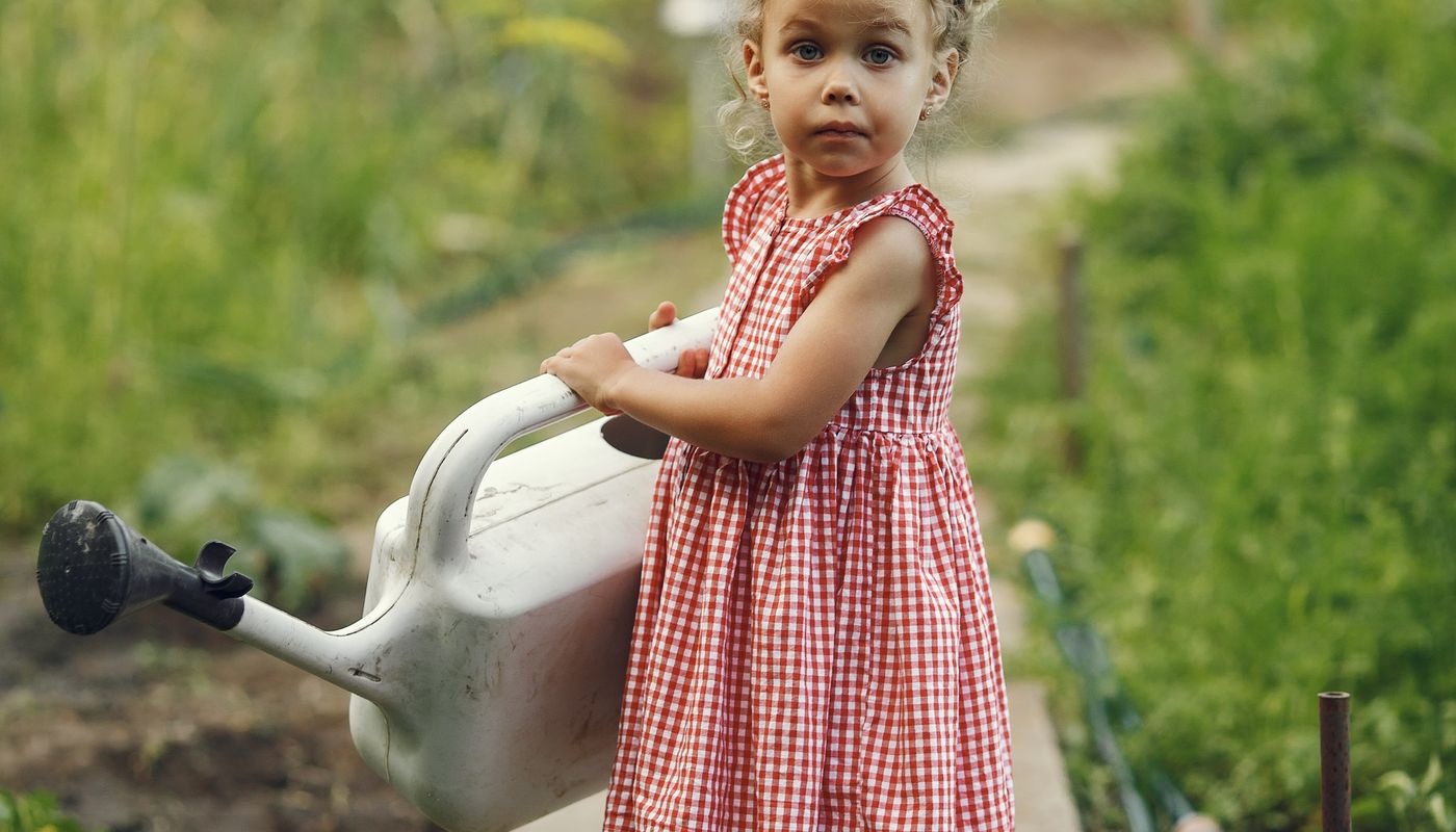 organic family garden — Child Holding Watering Can in Garden · Free. Photo: Pexels