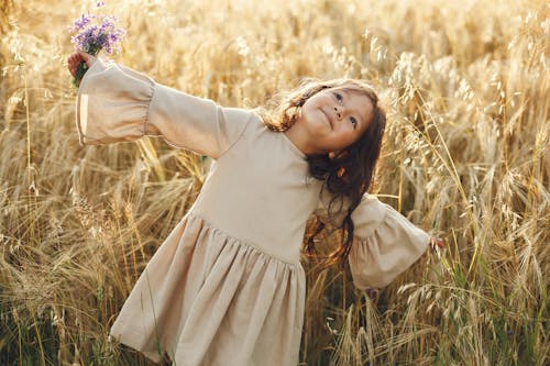 Happy Girl in Yellow Autumn Field
