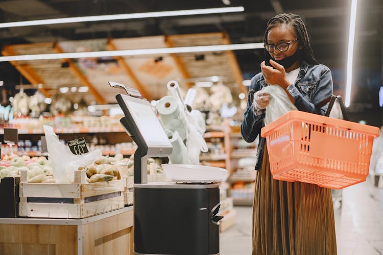 Happy Woman Grocery Shopping In Supermarket