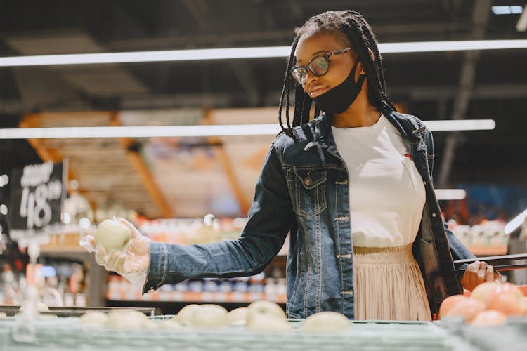 Woman In Supermarket Picking Fruits