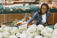 Woman in Blue Denim Jacket Holding Green Vegetable