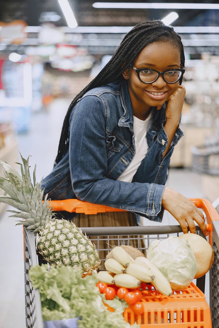 Smiling Young Woman With Shopping Cart