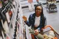 Woman in Black Leather Jacket Holding Pineapple Fruit