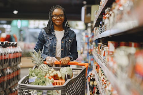 Free A Woman Pushing a Cart in a Grocery Store Stock Photo