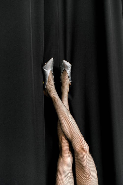 Close-up of a woman's legs wearing ankle socks in high heel shoes