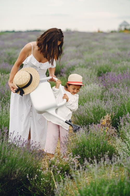 A Mother and Daughter Watering Plants