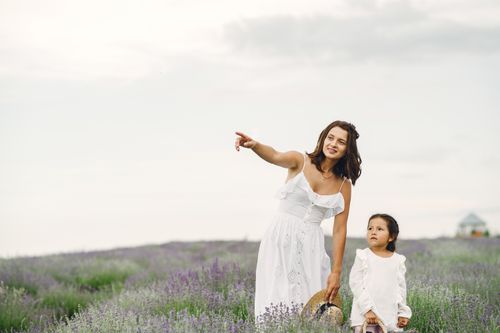 Free A mother and daughter in a lavender field enjoying a summer day outdoors. Stock Photo