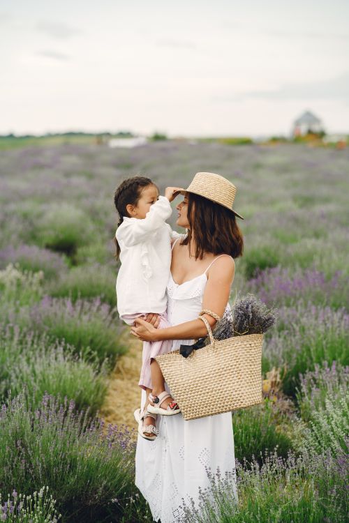 Free A mother and daughter enjoy a moment together in a lavender field, capturing a warm and joyful bond. Stock Photo