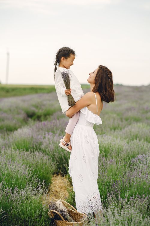 Free A mother and daughter share a joyful moment in a lavender field, embracing nature's beauty. Stock Photo