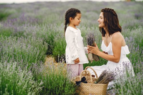 Free A joyful moment between mother and daughter in a lush lavender field, celebrating nature and togetherness. Stock Photo