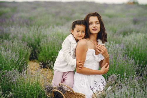 Free A mother and daughter share a tender moment in a scenic lavender field. Stock Photo