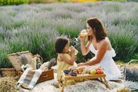 Woman and a Girl Drinking Orange Juice on Picnic in Heather