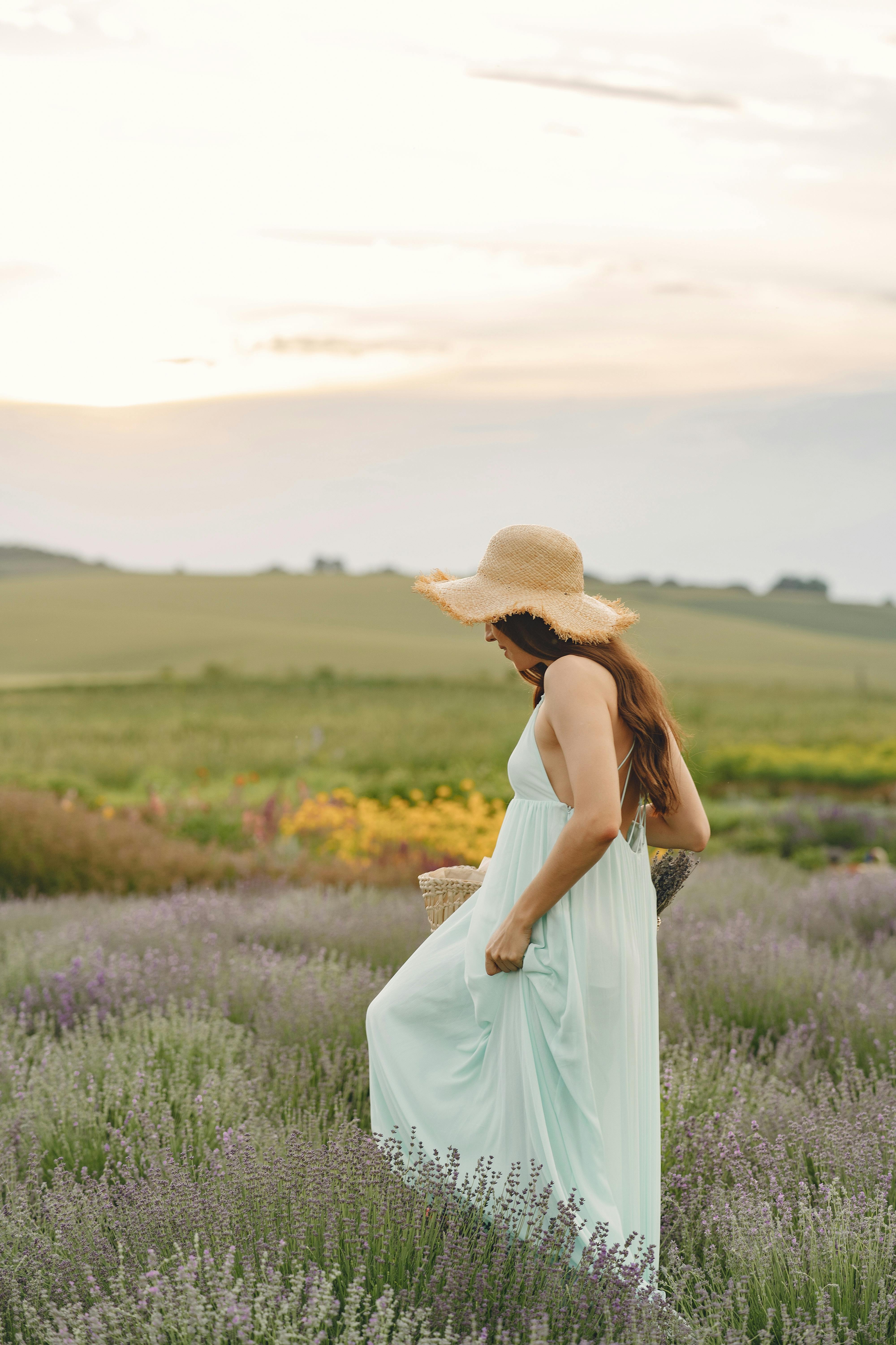 A Pretty Woman in Yellow Dress Sitting on a Grassy Field · Free Stock Photo