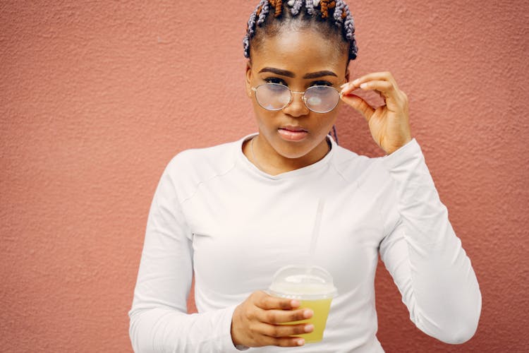 Woman Wearing Glasses Holding Cup Of Juice