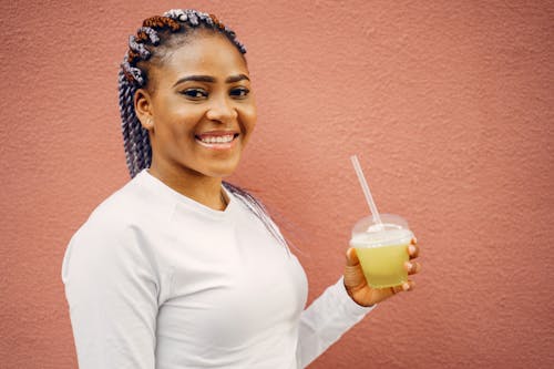 Free Portrait of Woman Holding Drink and Smile Stock Photo