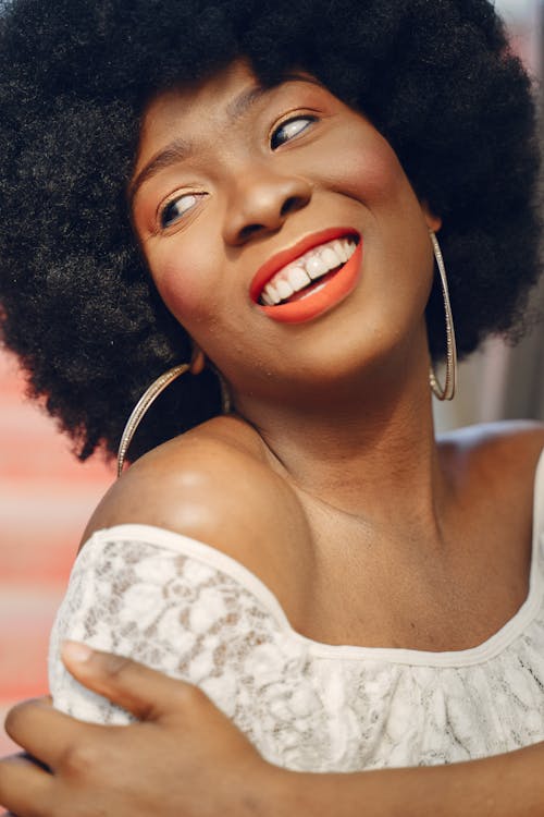 Free Portrait of a Woman with Hoop Earrings Smiling Stock Photo