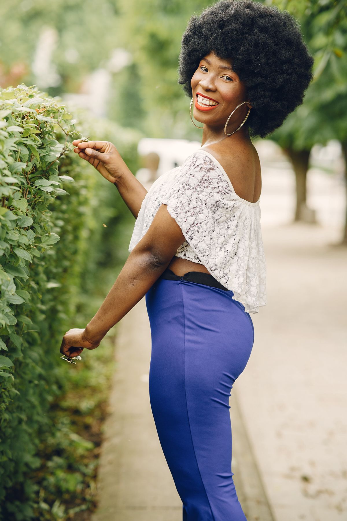 Smiling woman with curly hair outdoors