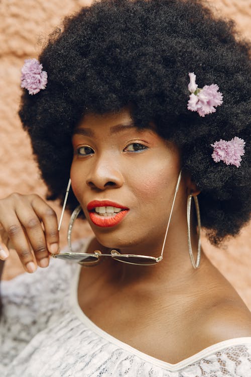 Beautiful Woman With Flowers in Afro