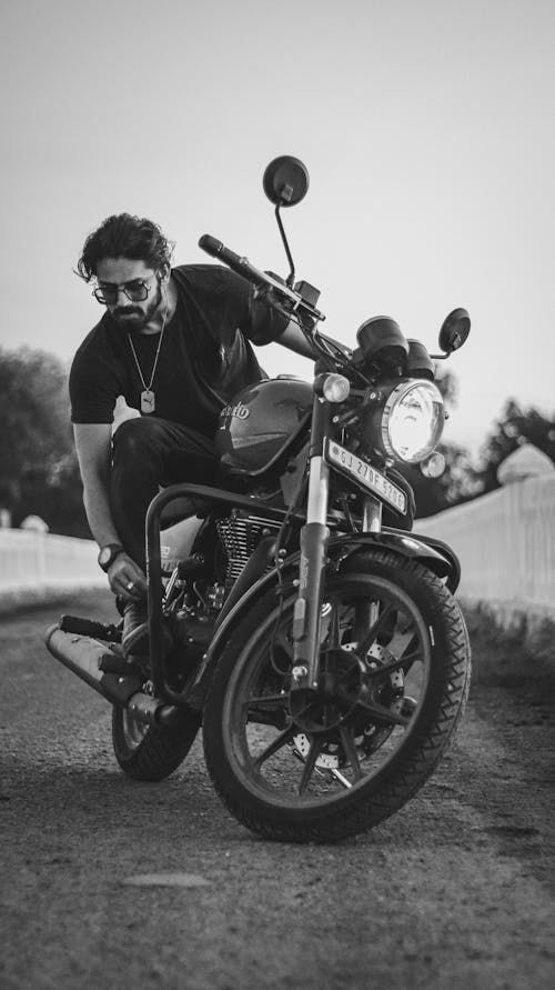 Monochrome Photo of Man riding a Motorcycle