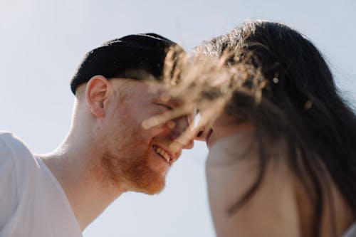 Man in White Dress Shirt Covering His Face