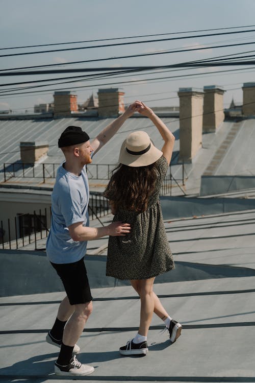 Man and Woman Standing on Sidewalk