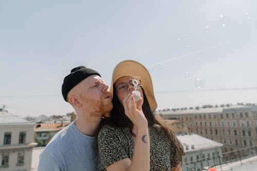 Man and Woman Smiling While Holding Hands