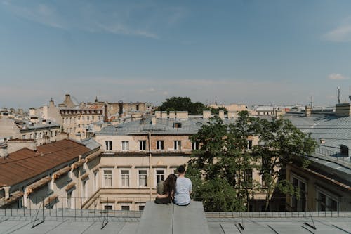 Woman in White Dress Sitting on Gray Concrete Bench