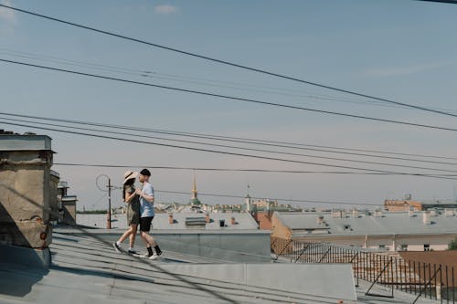 Man in White T-shirt and Black Shorts Running on Gray Concrete Road