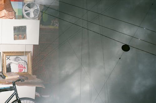 Shop Window and Reflected Electrical Lines and Clouds