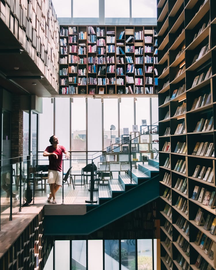 Man In Red Shirt At A Library