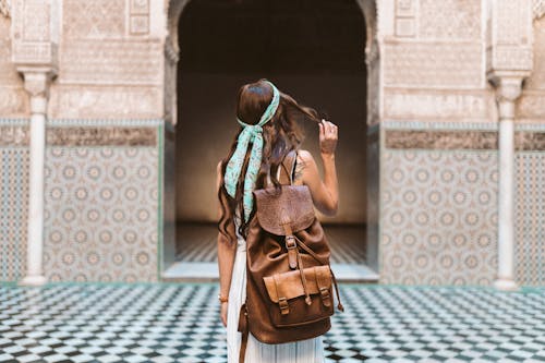 A Woman Carrying a Brown Leather Rucksack