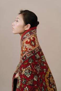 Profile of a woman wrapped in a traditional Russian-style shawl with intricate floral patterns.