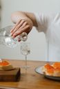 Person Pouring Water on Clear Drinking Glass