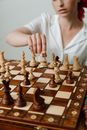 Person Playing Chess Game on Chess Board