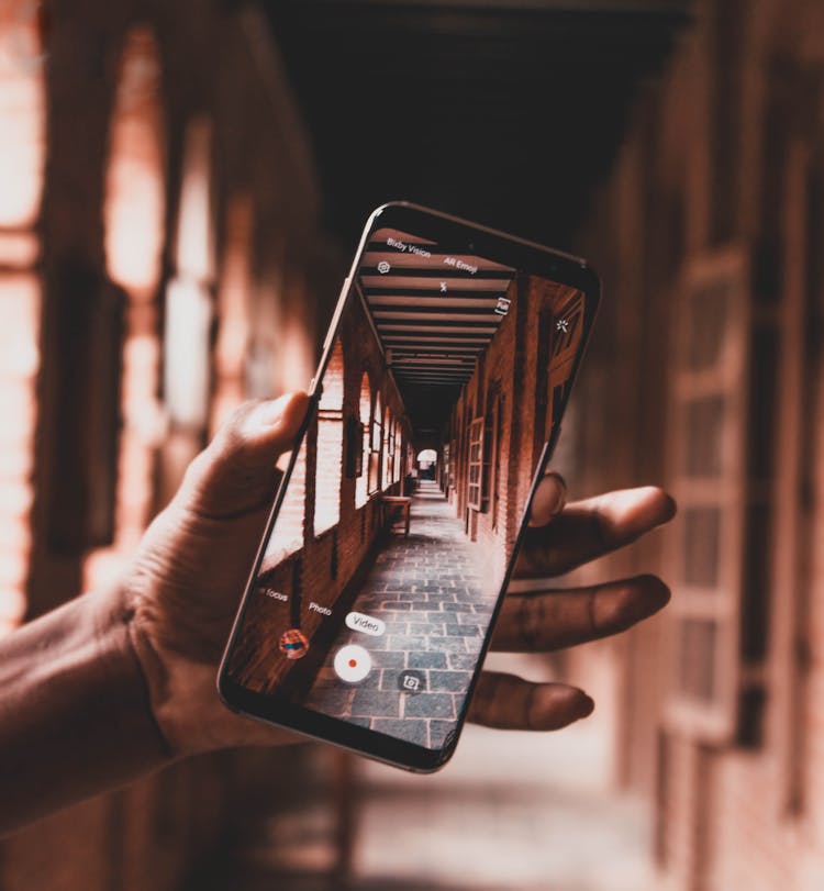 Person Hand Holding Cellphone Filming Historical Building Interior