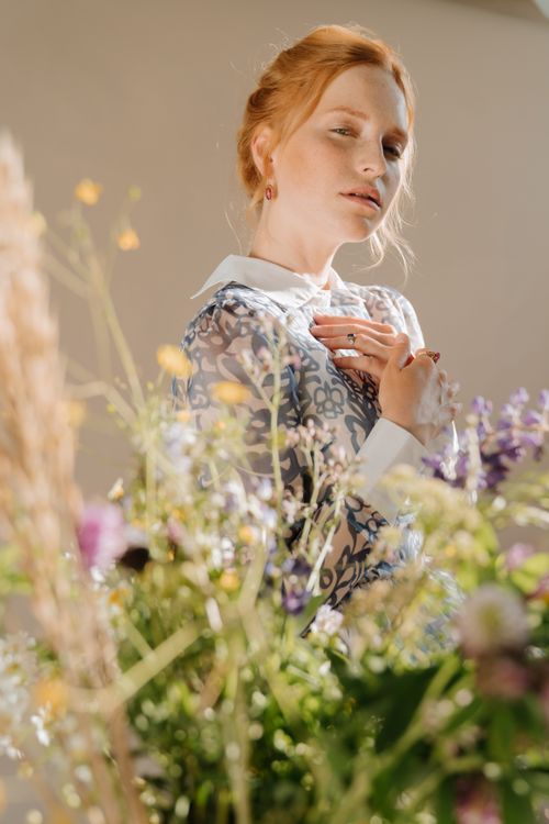 Woman in White and Blue Floral Shirt Holding Her Hair · Free Stock Photo