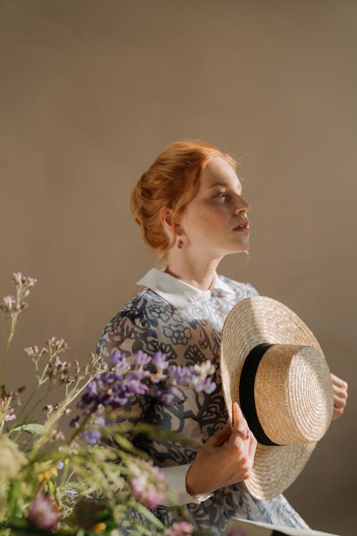 Woman in Purple and White Floral Dress Wearing Brown Sun Hat