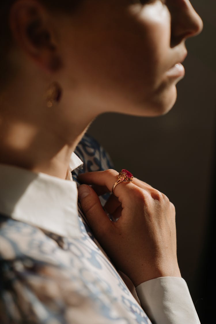 Woman In White And Blue Floral Shirt Wearing Silver Ring