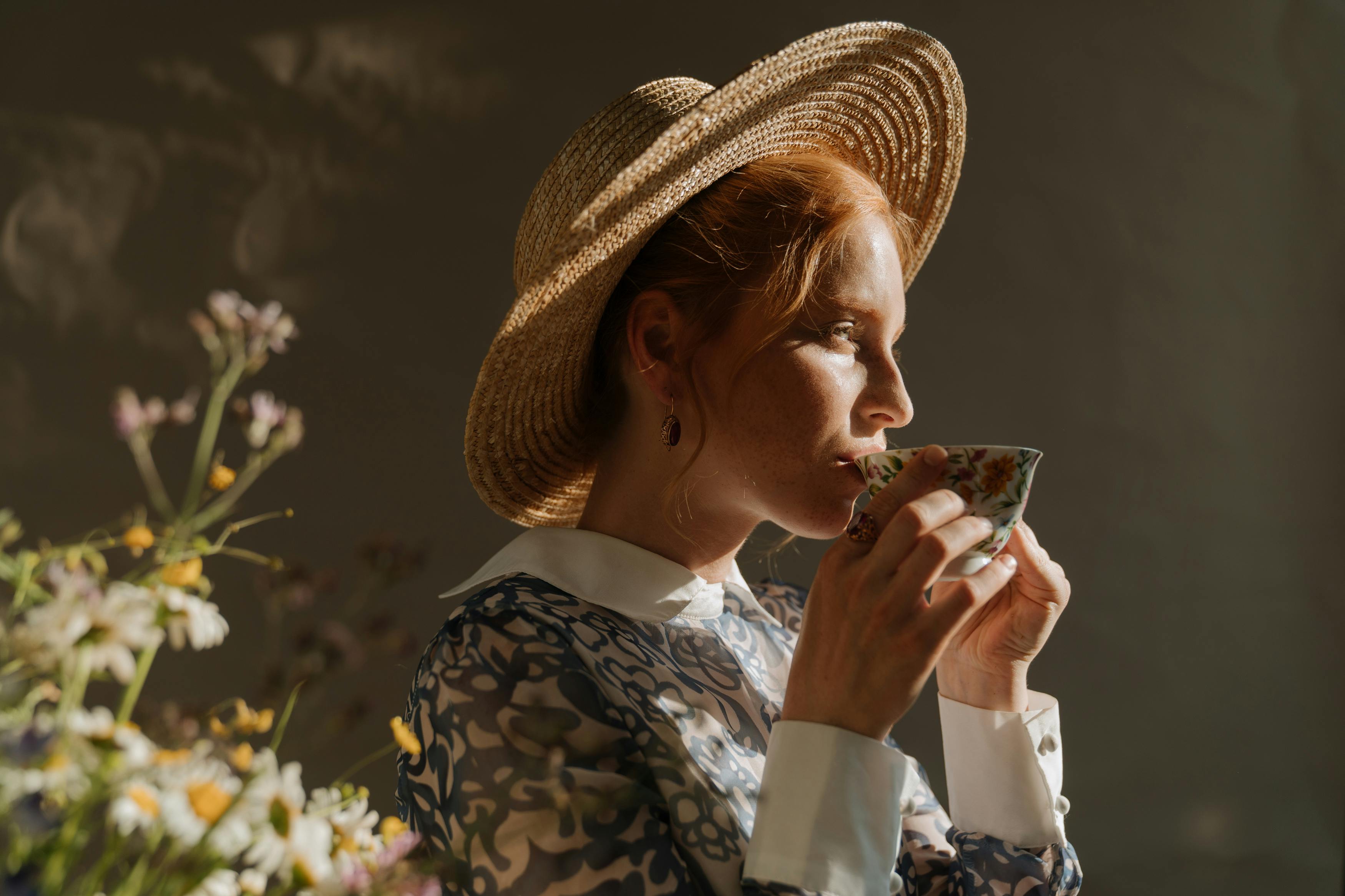 woman in brown sun hat and white long sleeve shirt