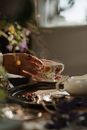 White and Red Floral Ceramic Teacup on Saucer