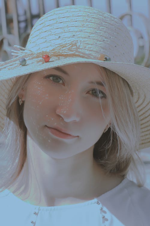 Close-Up Shot of a Beautiful Woman Wearing Floppy Straw Hat
