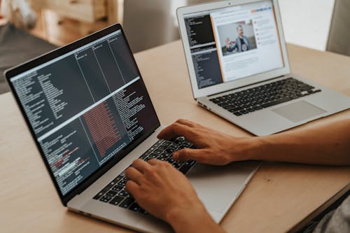 Person Coding on a Macbook Pro