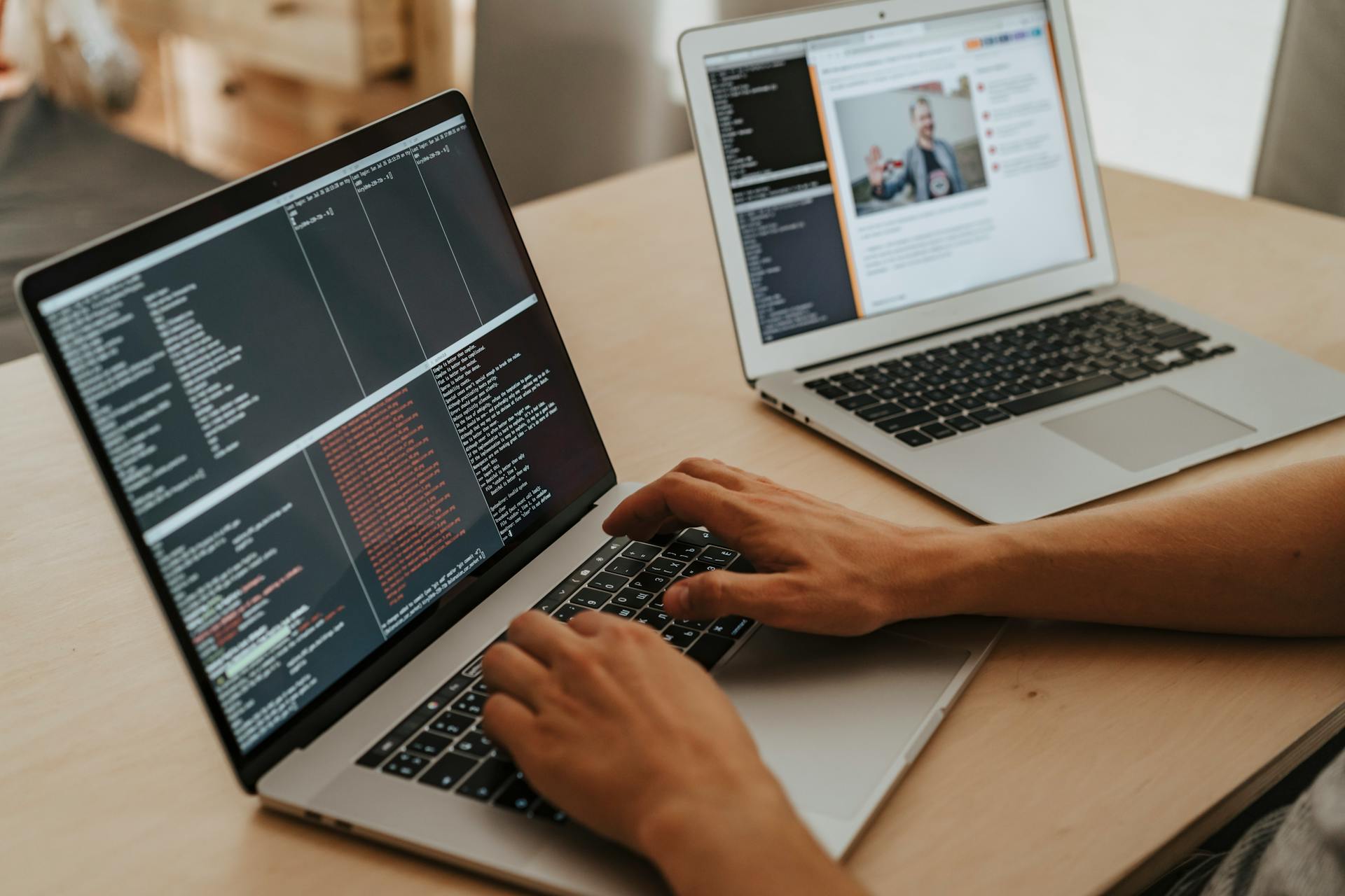 A developer working on a laptop, typing code, showcasing programming and technology skills.