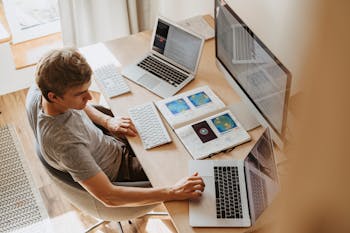 Man Using 3 Computers