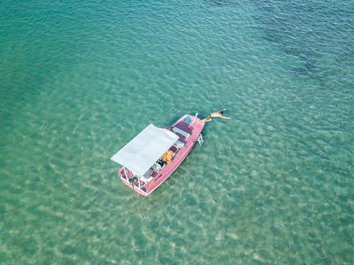 Free Aerial View of Red and White Boat on Sea Stock Photo