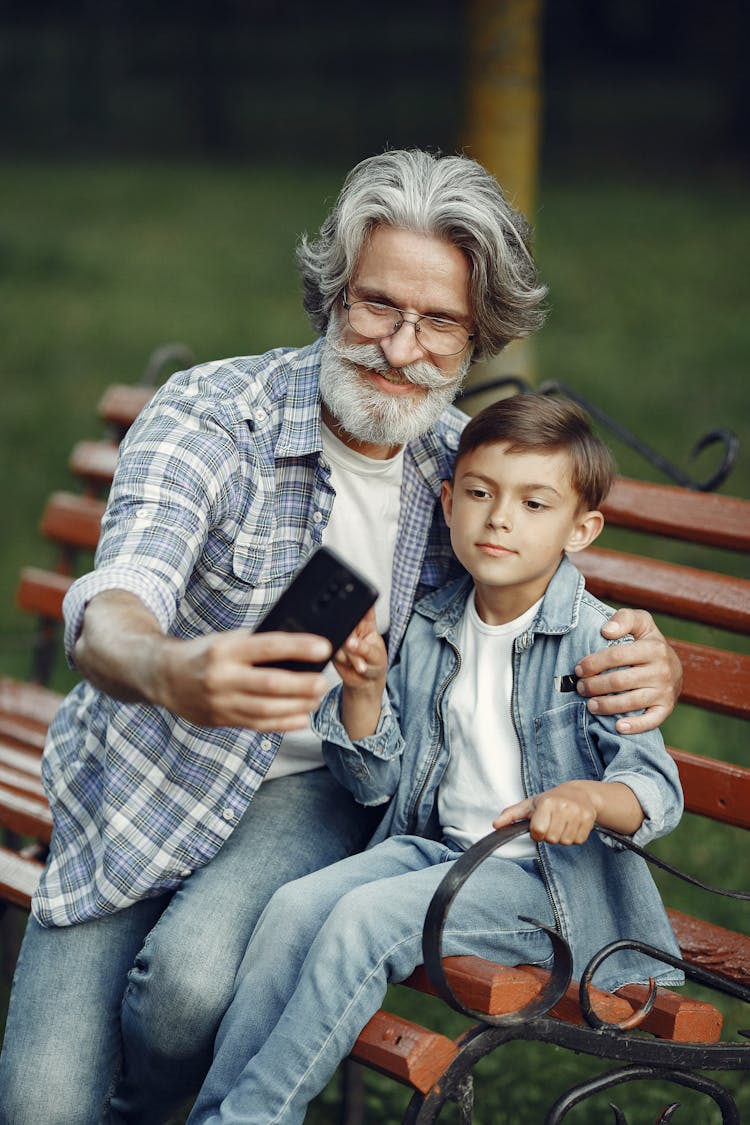 Happy Elderly Man And Child Making Selfie